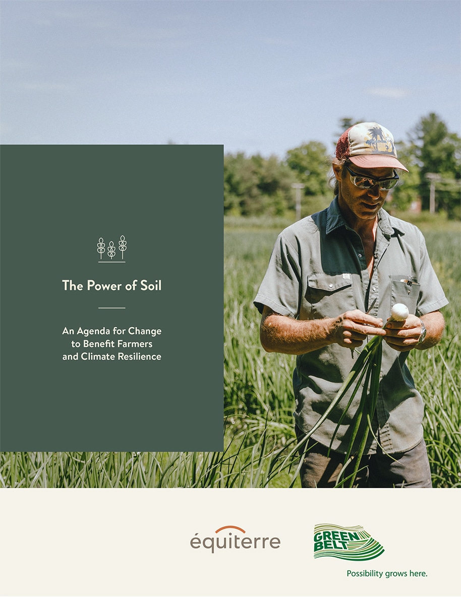 The Power of Soil report cover featuring a farmer inspecting an onion in the field.