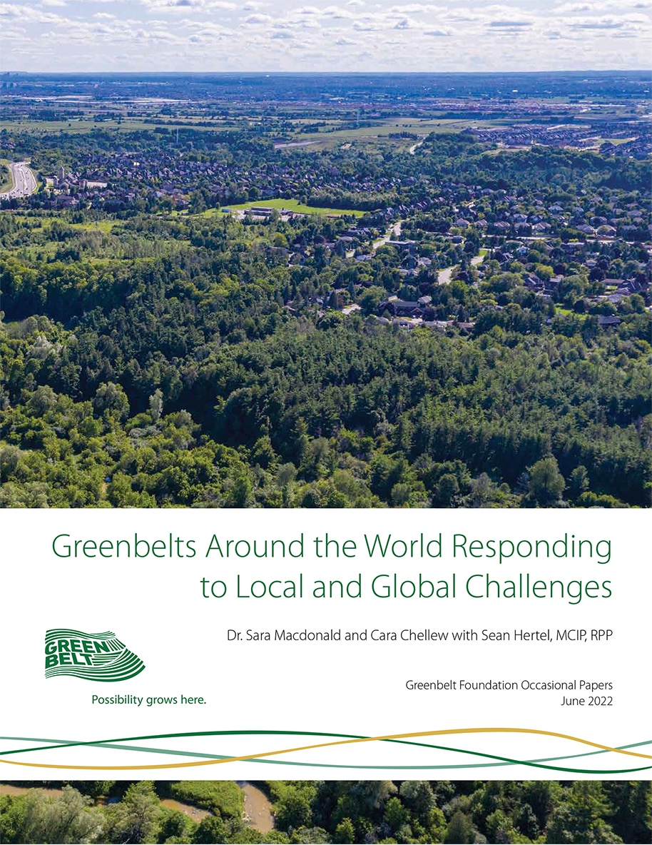 Cover of Greenbelts Around the World Responding to Local and Global Challenges featuring an aerial photograph showing a dense forest in the foreground with a suburban neighbourhood and farmland stretching into the horizon under a partly cloudy sky.