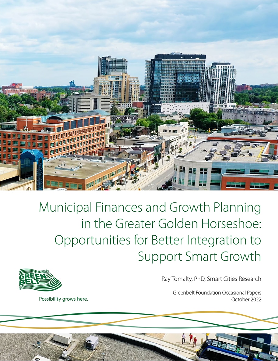 Report cover featuring a cityscape with mid- and high-rise buildings under a partly cloudy sky, viewed from above a busy street lined with smaller shops and offices.