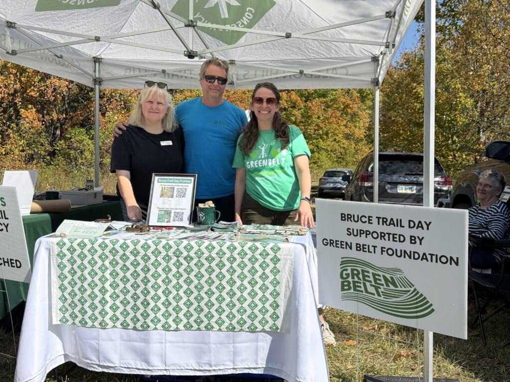 Foundation and Bruce Trail staff smiling at a table at Bruce Trail Day