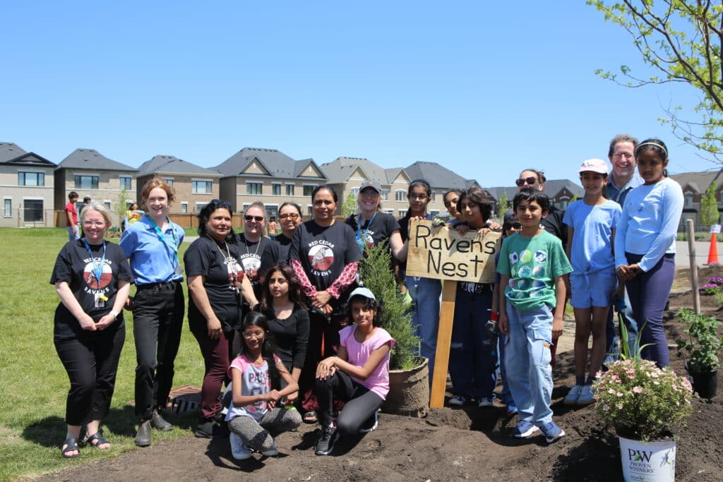 Group of children and adults planting trees